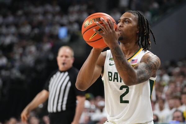 Baylor's Jayden Nunn prepares to shoot against Kansas during the first half of an NCAA college basketball game, Saturday, March 2, 2024, in Waco, Texas. (AP Photo/Julio Cortez)