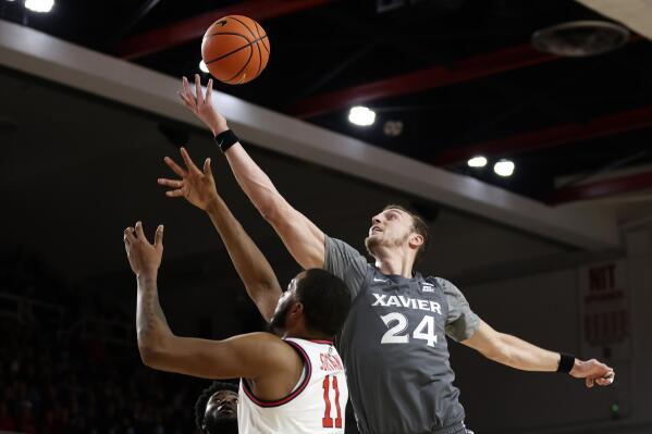 Xavier forward Jack Nunge (24) grabs a rebound over St. John's center Joel Soriano during the first half of an NCAA college basketball game Wednesday, Dec. 28, 2022, in New York. (AP Photo/Adam Hunger)