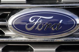 FILE - In this April 25, 2021 file photograph, the blue oval logo of Ford Motor Company is shown in east Denver. Ford plans to open a battery development center near Detroit by the end of next year. The company said the 200,000-square-foot facility will have equipment to design, test and even do small-scale manufacturing of battery cells and packs. (AP Photo/David Zalubowski, File)
