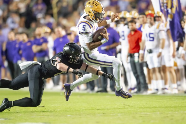 LSU quarterback Jayden Daniels (5) runs the ball against Army during an NCAA college football game in Baton Rouge, La., Saturday, Oct. 21, 2023. (Scott Clause/The Daily Advertiser via AP)