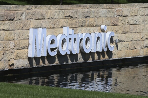 FILE - The Medronic logo is reflected in a lake at the company's offices in Fridley, Minn., on Aug. 29, 2019. An executive at a medical device company has been convicted in Minnesota of insider trading for a scheme involving negotiations for the acquisition of the firm that was valued at $1.6 billion, prosecutors said Tuesday, Feb. 20, 2024. Doron Tavlin was a vice president for business development at the Minneapolis office of Mazor Robotics in 2018 when he learned there was the potential that the company could be purchased by Israeli-based Medtronic, Inc., according to a statement from the U.S. Attorney's Office. (AP Photo/Jim Mone, File)