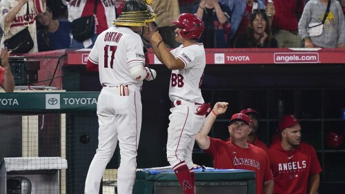 Los Angeles Angels designated hitter Shohei Ohtani (17) is given the kabuto after his home run against the Houston Astros during the ninth inning of a baseball game Saturday, July 15, 2023, in Anaheim, Calif. (AP Photo/Ryan Sun)