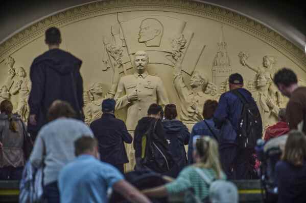 Passengers walk in front of a monument to Soviet leader Josef Stalin at the Taganskaya subway station in Moscow, Russia, on Wednesday, May 21, 2025. (AP Photo/Alexander Zemlianichenko, File)
