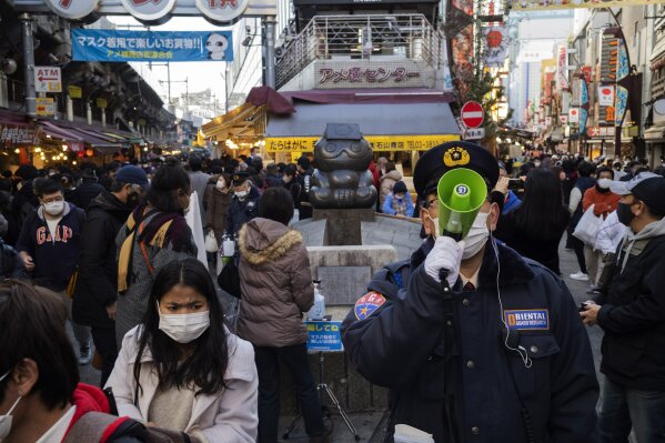 People flock to a shopping street for their yearend shopping in Tokyo Thursday, Dec. 31, 2020. (AP Photo/Hiro Komae)