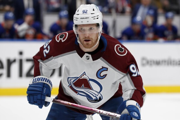 FILE - Colorado Avalanche left wing Gabriel Landeskog skates against the New York Islanders during an NHL hockey game March 7, 2022, in Elmont, N.Y. Landeskog sees a clearer path back to the ice even if he's not expected to play this season. That's how encouraged he is 4 1/2 months removed from cartilage replacement surgery on his right knee. His coach is optimistic, too, which is why Jared Bednar won't name a captain for the upcoming season. He's going to wait for Landeskog. (AP Photo/Jim McIsaac, File)