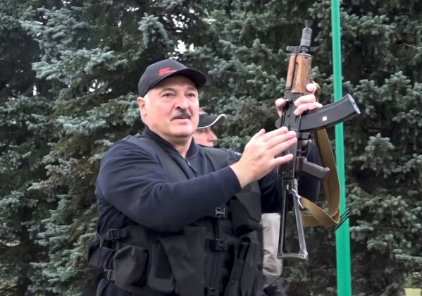 FILE - In this photo made from video that was provided by the State TV and Radio Company of Belarus, President Alexander Lukashenko wields a rifle near the Palace of Independence in Minsk, Belarus, on Sunday, Aug. 23, 2020. Thousands of people protested the results of the widely disputed presidential election that kept him in power. To try to quash the protests, his government cracked down on demonstrators, detaining thousands. (State TV and Radio Company of Belarus via AP, File)