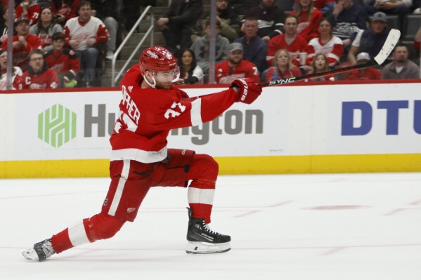 Detroit Red Wings left wing J.T. Compher (37) scores against the Washington Capitals during the second period of an NHL hockey game Tuesday, Feb. 27, 2024, in Detroit. (AP Photo/Duane Burleson)