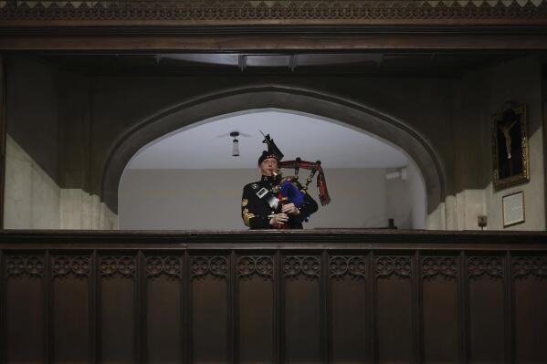 A piper plays during the funeral of Britain's Queen Elizabeth II, in London, Monday Sept. 19, 2022. (Phil Noble/Pool Photo via AP)