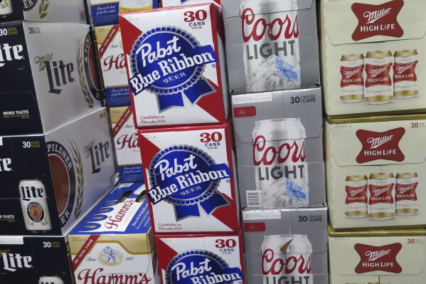 FILE - In this Nov. 8, 2018, file photo, cases of beer are stacked next to each other in a Milwaukee liquor store. Wisconsin's alcohol industry is getting behind an overhaul of the state’s alcohol laws that would lead to stricter enforcement efforts The measure has been hammered out in secret the past five years largely between Republican lawmakers and the multi-billion dollar alcohol industry. (AP Photo/Ivan Moreno, File)