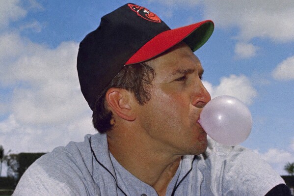 FILE - Brooks Robinson, third baseman for the Baltimore Orioles, blows a bubble in 1969. Robinson, whose deft glovework and folksy manner made him one of the most beloved and accomplished athletes in Baltimore history, has died. He was 86. The Orioles announced his death in a joint statement with Robinson's family Tuesday, Sept. 26, 2023. The statement did not say how Robinson died. (AP Photo, File)