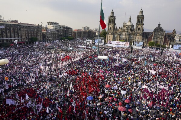 FILE - Supporters of presidential candidate Claudia Sheinbaum crowd into the Zocalo, facing the Cathedral, for her opening campaign rally in the Zocalo of Mexico City, March 1, 2024. Voters will choose on June 2, a new president, 628 congressmen and thousands of local positions according to the National Electoral Institute.(AP Photo/Aurea Del Rosario, File)