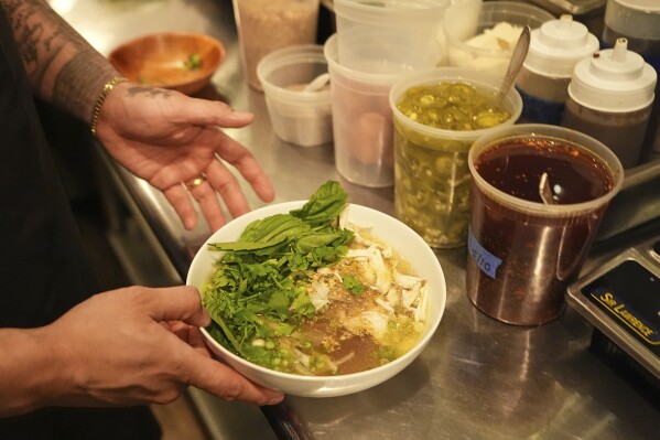 Chef Phila Lorn holds a bowl of the The Mawn Noodle soup at his restaurant, Mawn, in Philadelphia, Thursday, May 22, 2025. (AP Photo/Matt Rourke)