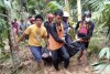 In this image made from video, rescuers carry the body of a victim of a flash flood in Langgai, West Sumatra, Indonesia, Sunday, March 10, 2024. Torrential rains have triggered flash floods and a landslide on Indonesia's Sumatra island leaving a number of people dead and missing, officials said Sunday. (AP Photo)