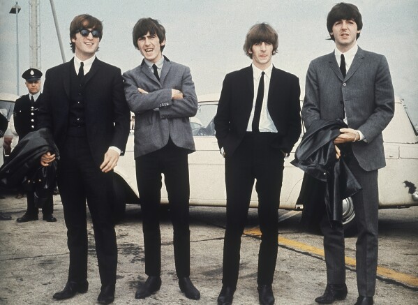 FILE - The Beatles, from left, John Lennon, George Harrison, Ringo Starr and Paul McCartney arrive in Liverpool, England on July 10, 1964, for the premiere of their movie "A Hard Day's Night." The final Beatles recording featuring John, Paul, George and Ringo is here. Released Thursday and titled “Now and Then,” the song comes from a batch of unreleased demos written by the late John Lennon in the ’70s. (AP Photo, File)