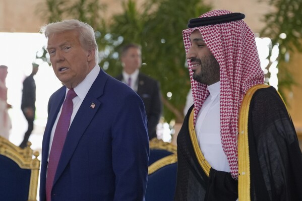 President Donald Trump speaks with Saudi Crown Prince Mohammed bin Salman during an arrival ceremony at the Royal Terminal of King Khalid International Airport in Riyadh, Saudi Arabia, Tuesday, May 13, 2025. (AP Photo/Alex Brandon)