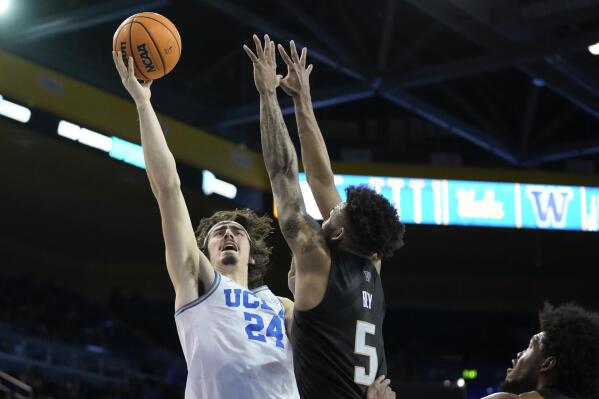 UCLA guard Jaime Jaquez Jr. (24) shoots against Washington guard Jamal Bey (5) during the second half of an NCAA college basketball game in Los Angeles, Thursday, Feb. 2, 2023. (AP Photo/Ashley Landis)