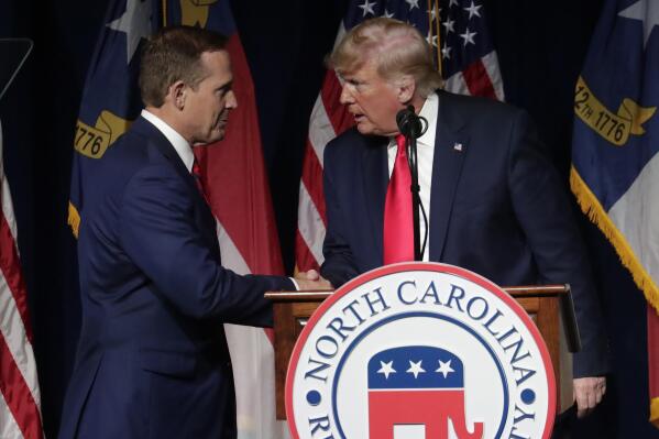 Former President Donald Trump, right, announces his endorsement of N.C. Rep. Ted Budd, left, for the 2022 North Carolina U.S. Senate seat as he speaks at the North Carolina Republican Convention Saturday, June 5, 2021, in Greenville, N.C. (AP Photo/Chris Seward)