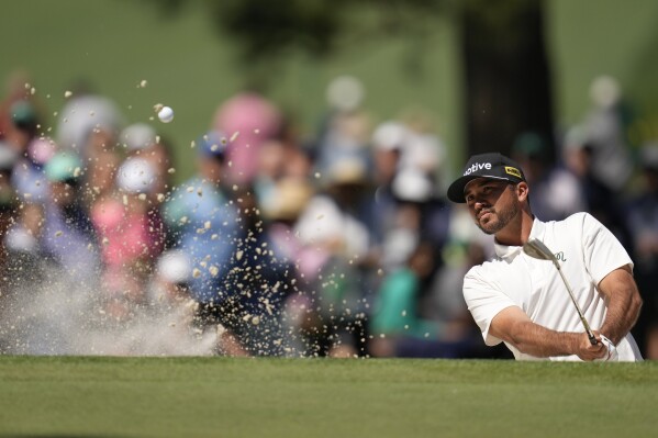FILE - Jason Day, of Australia, hits from the bunker on the seventh hole during second round at the Masters golf tournament at Augusta National Golf Club Friday, April 12, 2024, in Augusta, Ga. Day is the defending champion and two-time winner of an event fellow major champion Jordan Spieth would dearly like to win -- Spieth's hometown CJ Cup Byron Nelson golf tournament. They are the headliners in a field missing most of the big names, including soon-to-be-father Scottie Scheffler. (AP Photo/Ashley Landis, File)