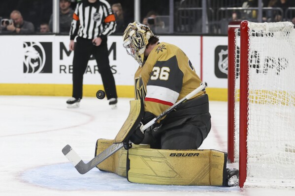 Vegas Golden Knights goaltender Logan Thompson makes a save against the Chicago Blackhawks during the third period of an NHL hockey game Tuesday, April 16, 2024, in Las Vegas. (AP Photo/Ian Maule)