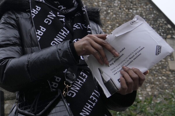 FILE - A woman leaves a polling station after voting in London, Thursday, May 2, 2024. Britain's governing Conservative Party is suffering heavy losses as local election results pour in Friday, piling pressure on Prime Minister Rishi Sunak ahead of a U.K. general election in which the main opposition Labour Party appears increasingly likely to return to power after 14 years. (AP Photo/Kin Cheung, File)