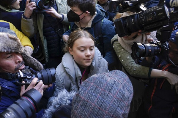 Climate activist Greta Thumberg, center, arrives at the Westminster Magistrates Court, in London, Wednesday, Nov. 15, 2023, where she has to appear, following her charges with a public order offence after she was arrested while taking part in a protest against a conference in London described as "the Oscars of oil". (AP Photo/Alberto Pezzali)