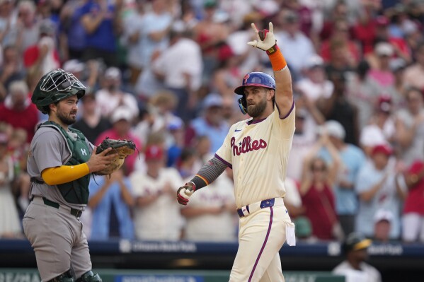 Philadelphia Phillies' Bryce Harper reacts after hitting a home run against Oakland Athletics pitcher Austin Adams during the seventh inning of a baseball game, Saturday, July 13, 2024, in Philadelphia. (AP Photo/Matt Slocum)