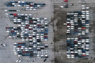 FILE - In this Wednesday, March 24, 2021 file photo, mid-sized pickup trucks and full-size vans are seen in a parking lot outside a General Motors assembly plant where they are produced in Wentzville, Mo. General Motors says efforts to manage the global computer chip shortage have worked better than expected, so it’s financial results will improve over previous forecasts. The company says in a statement Thursday, June 3, it has made engineering changes, prioritized semiconductor use and pulled some potential deliveries into the second quarter. (AP Photo/Jeff Roberson, File)