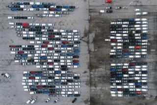 FILE - In this Wednesday, March 24, 2021 file photo, mid-sized pickup trucks and full-size vans are seen in a parking lot outside a General Motors assembly plant where they are produced in Wentzville, Mo.  General Motors says efforts to manage the global computer chip shortage have worked better than expected, so it’s financial results will improve over previous forecasts. The company says in a statement Thursday, June 3,  it has made engineering changes, prioritized semiconductor use and pulled some potential deliveries into the second quarter. (AP Photo/Jeff Roberson, File)