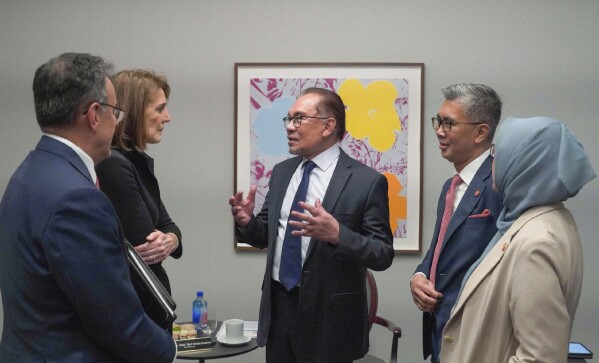 In this photo provided by Malaysia’s Ministry of Investment, Trade and Industry, Malaysian Prime Minister Anwar Ibrahim, center, talks with Ruth Porat, second left, Alphabet Inc.'s president and chief financial officer, in New York, NY., on Sept. 2023. Google pledged Thursday, May 30, 2024, to commit $2 billion in Malaysia, including building its first data center and Google Cloud region in its biggest planned investment in the Southeast Asian country.(Malaysia’s Ministry of Investment, Trade and Industry via AP)