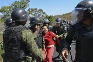 FILE - A woman is detained by Mexican army military police in a neighborhood in the city of Chilpancingo, Mexico, Friday, Feb. 6, 2015. Mexico´s Supreme Court ruled Tuesday, Jan 24, 2023, that soldiers can make an arrest without telling police, as long as they eventually register the arrest in a computer system that civilian agencies use. (AP Photo/Alejandrino Gonzalez, File)