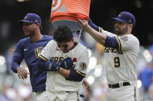 Milwaukee Brewers' Luis Urias, center, is congratulated by Manny Pina, right, and Freddy Peralta, left, after hitting a walk-off RBI single during the tenth inning of a baseball game against the Detroit Tigers Monday, May 31, 2021, in Milwaukee. (AP Photo/Aaron Gash)