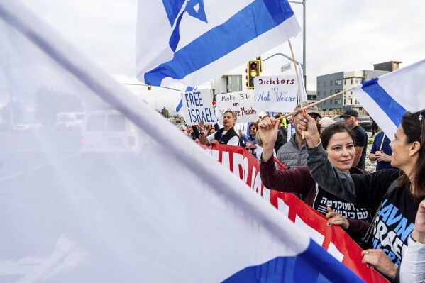 Protesters rally outside Tesla's Fremont, Calif., factory as Israeli Prime Minister Benjamin Netanyahu plans a visit with businessman Elon Musk on Monday, Sept. 18, 2023. (AP Photo/Noah Berger)