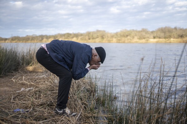 Mimoun Nadori tastes water out of the Moulouya River to check its salinity, in Nador, north of Morocco, Friday, March 8, 2024. (AP Photo/Mosa'ab Elshamy)