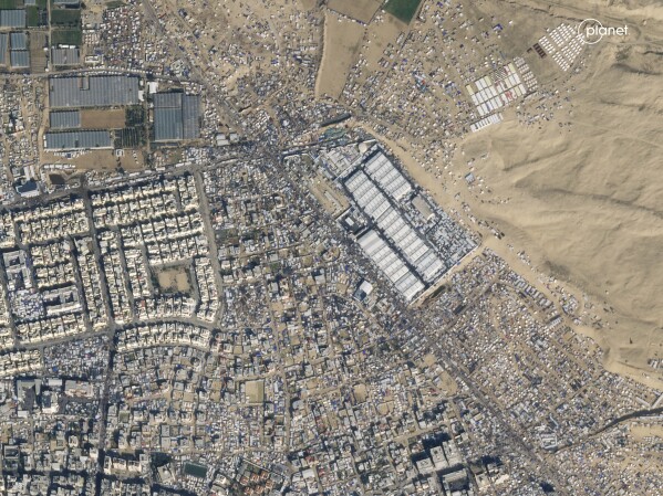 This satellite image from Planet Labs PBC shows the city of Rafah in southern Gaza on January 14, 2024. The city is normally home to 280,000 people.  But the population has swelled to more than 1.5 million people — roughly three-quarters of Gaza's population — as people flee fighting elsewhere in Gaza.  Vast tent camps are now spread across the city.  (Planet Labs PBC via AP)