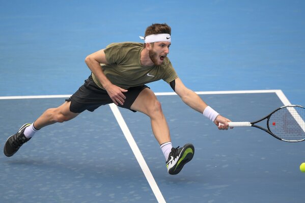 France's Corentin Moutet makes a forehand return to United States' Frances Tiafoe during a tuneup tournament ahead of the Australian Open tennis championships in Melbourne, Australia, Monday, Feb. 1, 2021. (AP Photo/Andrew Brownbill)