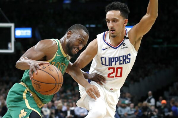 Boston Celtics guard Kemba Walker drives against Los Angeles Clippers guard Landry Shamet (20) in the first half of an NBA basketball game, Thursday, Feb. 13, 2020, in Boston. (AP Photo/Elise Amendola)