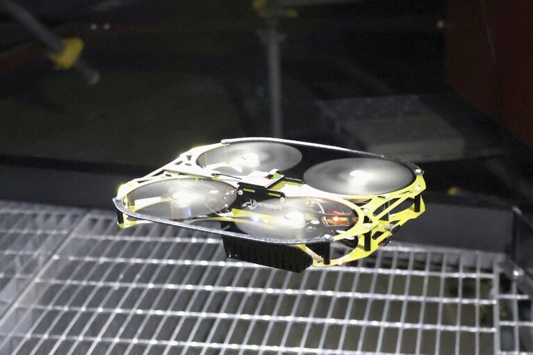 FILE - This photo shows a drone designed to probe at the crippled Fukushima Daiichi nuclear power plant, while in demonstration in Naraha town, northeast of Japan, Tuesday, Jan. 23, 2024. Images taken by miniature drones from deep inside a badly damaged reactor at the Fukushima nuclear plant show displaced control equipment and misshapen materials but leave many questions unanswered, underscoring the daunting task of decommissioning the plant.(Daisuke Kojima/Kyodo News via AP, File)