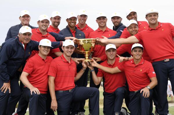 FILE - The U.S. team hold their trophy after they won the Presidents Cup golf tournament at Royal Melbourne Golf Club in Melbourne, Sunday, Dec. 15, 2019. The U.S. team won the tournament 16-14. The last Presidents Cup was so close the International team walked away with renewed hope that it had enough game and enough fight to conquer the mighty Americans. (AP Photo/Andy Brownbill, File)