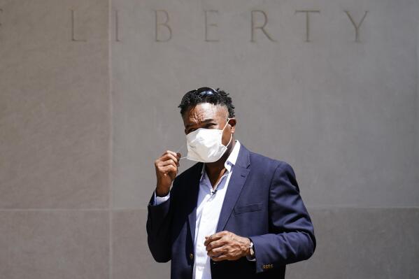 FILE - Former NFL player Ken Jenkins exits the building after delivering tens of thousands of petitions demanding equal treatment for everyone involved in the settlement of concussion claims against the NFL, to the federal courthouse in Philadelphia, on May 14, 2021. Hundreds of Black NFL retirees denied payouts in the $1 billion concussion settlement now qualify for awards after their tests were rescored to eliminate racial bias, according to a report released Friday, Aug, 12, 2022. (AP Photo/Matt Rourke, File)