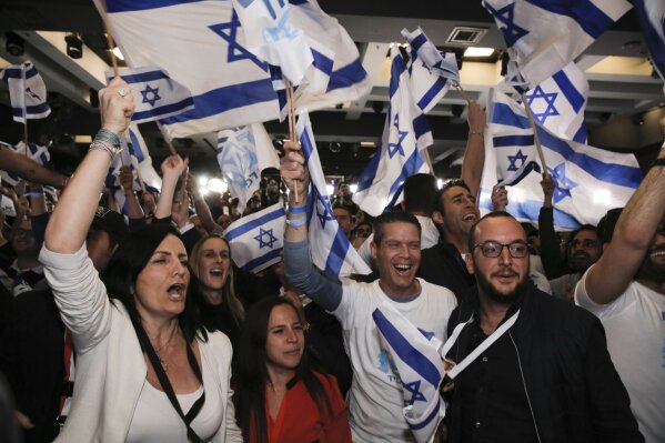 
              Blue and White part supporters cheer at the party's campaign headquarters after polls for Israel's general elections closed, in Tel Aviv, Tuesday, April 9, 2019. (AP Photo/Sebastian Scheiner)
            