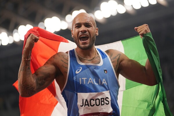 FILE - Lamont Marcell Jacobs, of Italy celebrates after winning the gold medal in the final of the men's 100-meters at the 2020 Summer Olympics, Sunday, Aug. 1, 2021, in Tokyo, Japan. Jacobs, the unheralded Italian sprinter who succeeded Usain Bolt as the 100-meter champion at the Tokyo Olympics, still feels like he has something to prove as he prepares to defend gold at the upcoming Paris Games. (AP Photo/Martin Meissner, File)