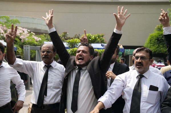 Lawyers and supporters of Pakistan's former Prime Minister Imran Khan chant slogans against the court decision at his residence, in Lahore, Pakistan, Saturday, Aug. 5, 2023. Pakistani police on Saturday arrested former Prime Minister Khan at his home in the eastern city of Lahore. It’s the second time the popular opposition leader has been detained this year.(AP Photo/K.M. Chaudary)