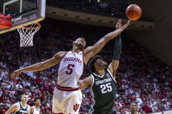 Indiana forward Malik Reneau (5) and Michigan State forward Malik Hall (25) reach for a rebound during the second half of an NCAA college basketball game, Sunday, March 10, 2024, in Bloomington, Ind. (AP Photo/Doug McSchooler)