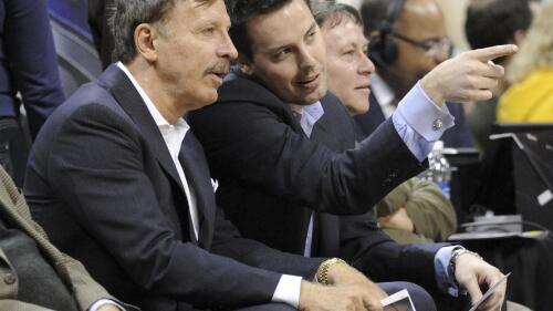 FILE - Stan Kroenke, left, owner of the Denver Nuggets, and his son Josh Kroenke watch during the first quarter of an NBA basketball game between the Nuggets and the San Antonio Spurs on March 23, 2011, in Denver. Stan Kroenke's deal to purchase the Nuggets, along with the Colorado Avalanche and their home arena for $450 million, included a clause that tethered the NBA franchise to Denver for the ensuing 25 years. These days, the Nuggets are estimated by Forbes to be worth $1.93 billion. And all talk of them relocating no longer exists. (AP Photo/Jack Dempsey, File)