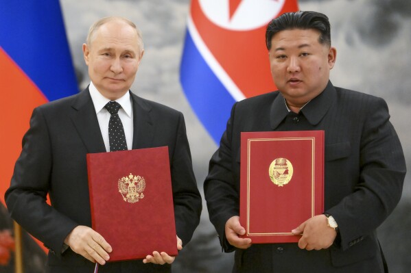 Russian President Vladimir Putin, left, and North Korean leader Kim Jong Un pose for a photo during a signing ceremony for the new partnership in Pyongyang, North Korea, Wednesday, June 19, 2024. (Kristina Kormilitsyna, Sputnik, Kremlin Pool Photo via PA)