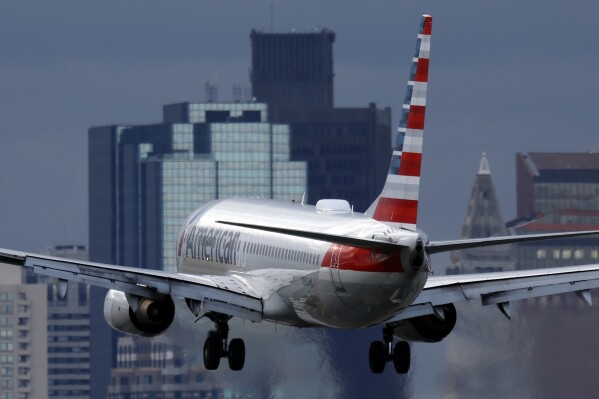 File - An American Airlines plane lands at Logan International Airport, Thursday, Jan. 26, 2023, in Boston. American Airlines earnings are reported on Thursday. (AP Photo/Michael Dwyer, File)