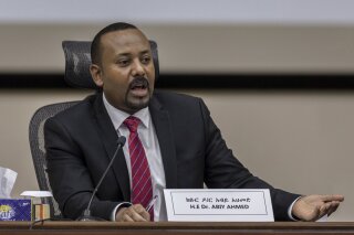 FILE - In this Monday, Nov. 30, 2020 file photo, Ethiopia's Prime Minister Abiy Ahmed responds to questions from members of parliament at the prime minister's office in the capital Addis Ababa, Ethiopia. Ethiopia's leader said in an address before lawmakers Tuesday, March 23, 2021 that atrocities have occurred in Tigray, the country's northern region where fighting persists as government troops hunt down its fugitive leaders. (AP Photo/Mulugeta Ayene, File)