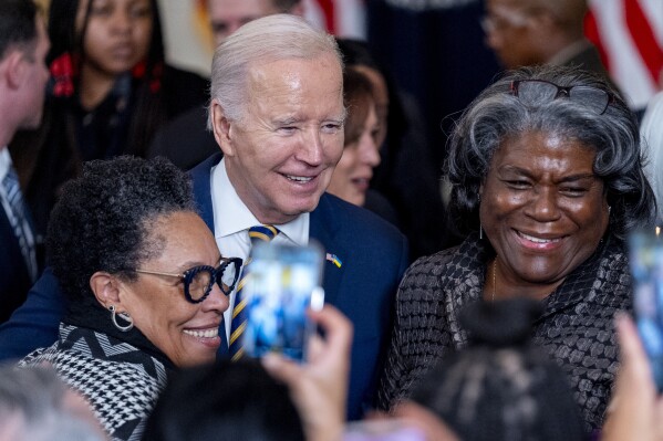 President Joe Biden takes a photograph with Housing and Urban Development Secretary Marcia Fudge, left, and United States Ambassador to the United Nations Linda Thomas-Greenfield, right, during a reception in recognition of Black History Month in the East Room of the White House in Washington, Tuesday, Feb. 6, 2024. (AP Photo/Andrew Harnik)