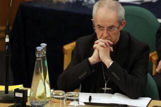 FILE - The Archbishop of Canterbury Justin Welby listens to debate at the General Synod in London, on Feb. 13, 2017. Less than half of people in England and Wales consider themselves Christian, according to the most recent census – the first time the country's official religion has been followed by a minority of the population. Figures from the 2021 census released Tuesday, Nov. 29, 2022, by the Office for National Statistics reveal that Britain has become less religious, and less white, in the decade since the last census in 2011.  (AP Photo/Alastair Grant)
