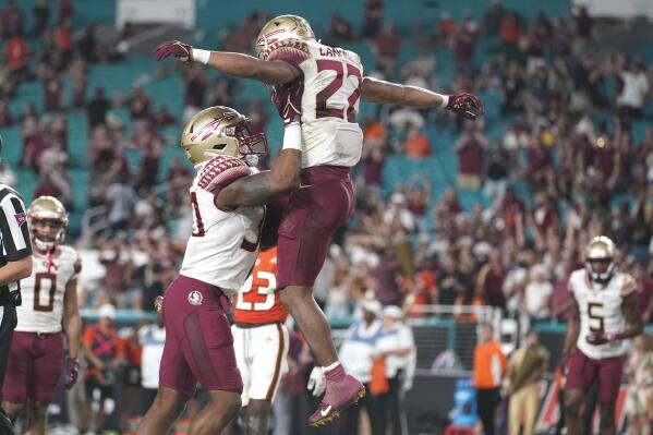 Florida State running back CJ Campbell (22) is lifted into the air by tight end DJ Daniels after scoring a touchdown during the second half of an NCAA college football game against Miami, Saturday, Nov. 5, 2022, in Miami Gardens, Fla.(AP Photo/Lynne Sladky)